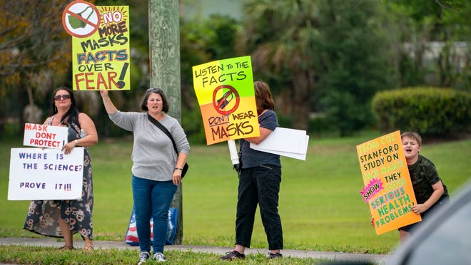 Anti-mask demonstrators stand along Forest Hill Blvd. outside the Palm Beach County School District offices during a school board meeting on April 21, 2021 in West Palm Beach, Florida. Greg Lovett, The Palm Beach Post
