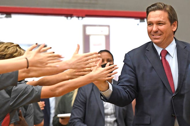 Gov. Ron DeSantis high-fives students in Sarasota
