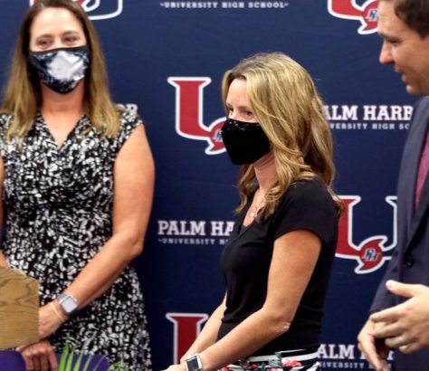 Sarah Painter, a fifth-grade teacher at Eisenhower Elementary and 2020-21 Teacher of the Year for Pinellas County Schools, center, is introduced by Gov. Ron DeSantis